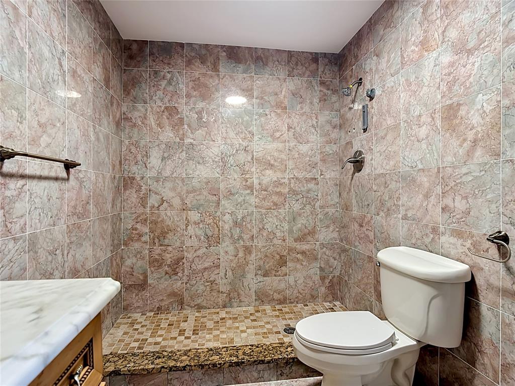 7925 Lake Mabel Loop Road Lake Wales, FL 33898 - Photo 48 of 97 a white toilet sitting next to a shower curtain