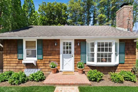 a front view of a house with garden