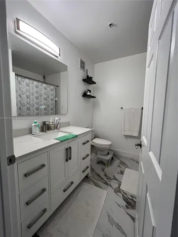 a spacious bathroom with a double vanity sink mirror and toilet