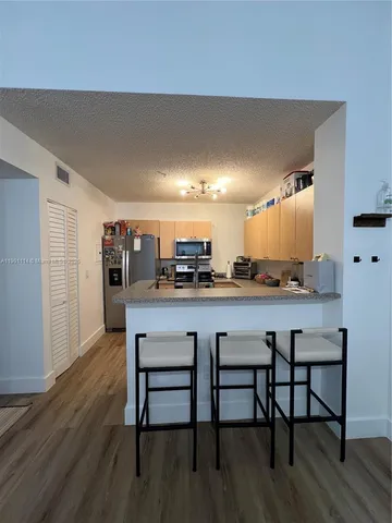 a kitchen with a table and chairs in it