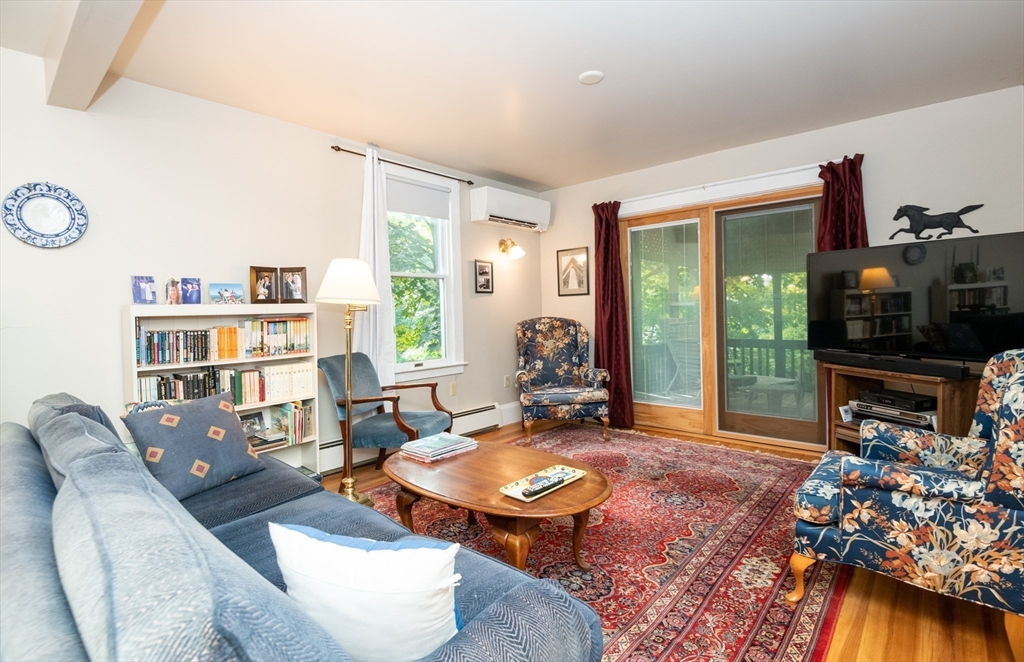 18 Lafayette Road Ipswich, MA 01938 - Photo 19 of 42 a living room with furniture a flat screen tv and a large window