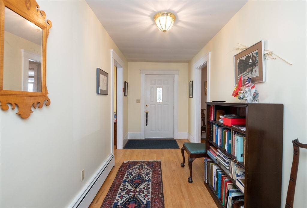 18 Lafayette Road Ipswich, MA 01938 - Photo 9 of 42 a view of a hallway with wooden floor and a workspace