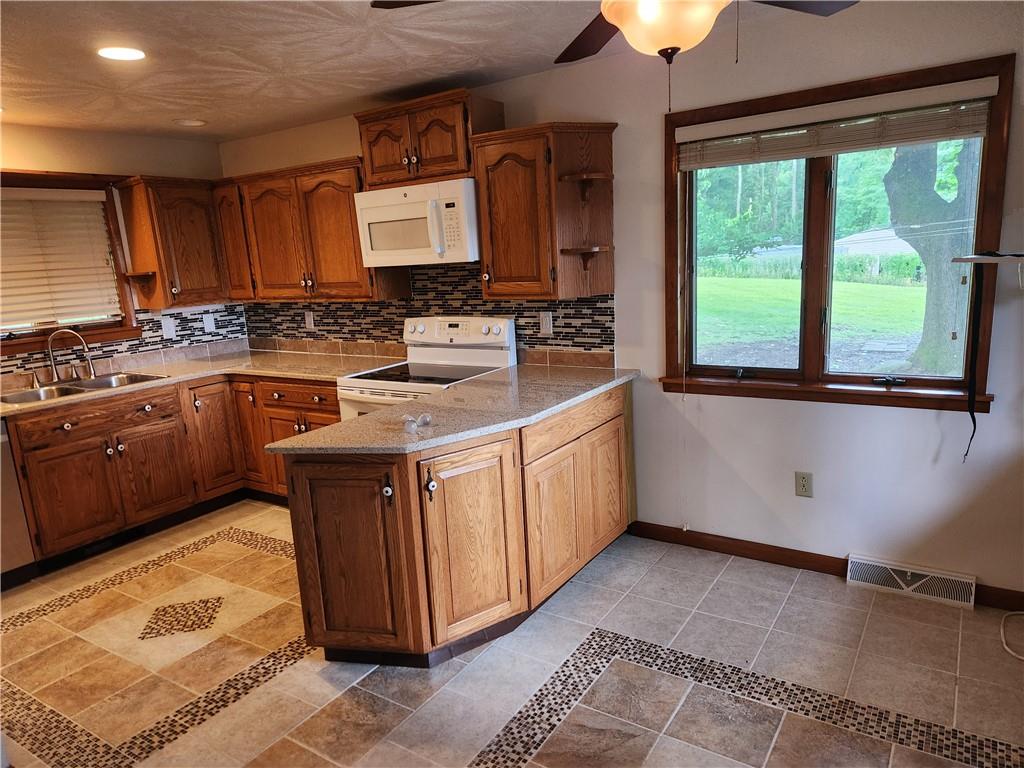 102 September Drive Butler, PA 16002 - Photo 11 of 26 a kitchen with a sink stove and cabinets