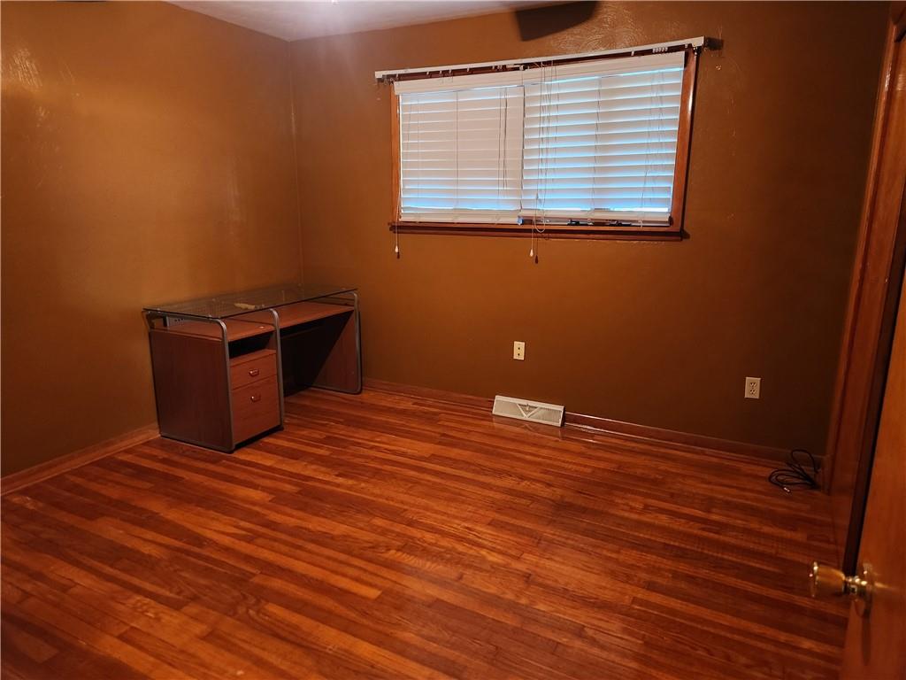 102 September Drive Butler, PA 16002 - Photo 17 of 26 a view of an empty room with wooden floor and a window