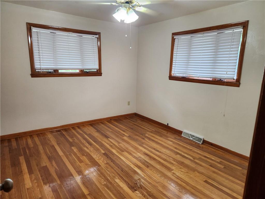 102 September Drive Butler, PA 16002 - Photo 19 of 26 a view of an empty room with wooden floor and a window