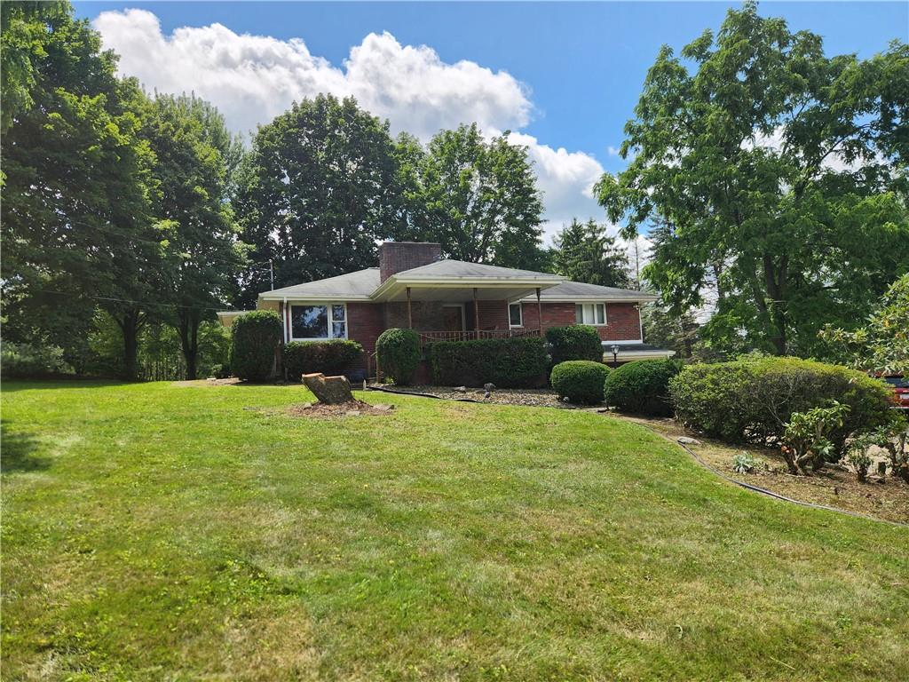 102 September Drive Butler, PA 16002 - Photo 4 of 26 a front view of a house with a garden