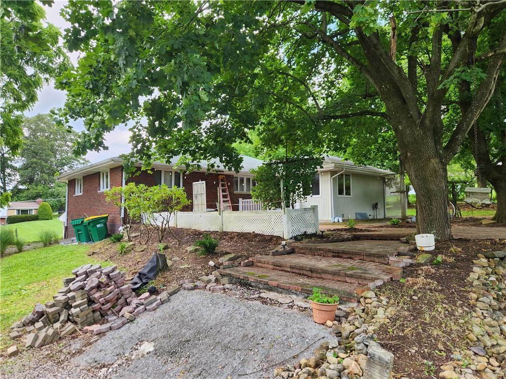 102 September Drive Butler, PA 16002 - Photo 5 of 26 a view of a yard with a house and large tree