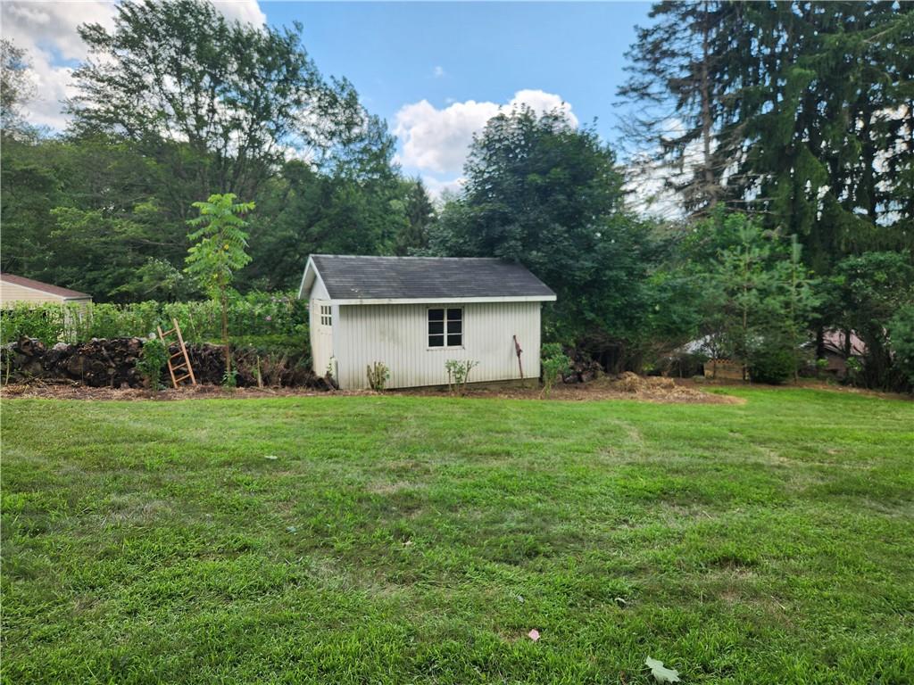 102 September Drive Butler, PA 16002 - Photo 6 of 26 a front view of a house with a yard and trees