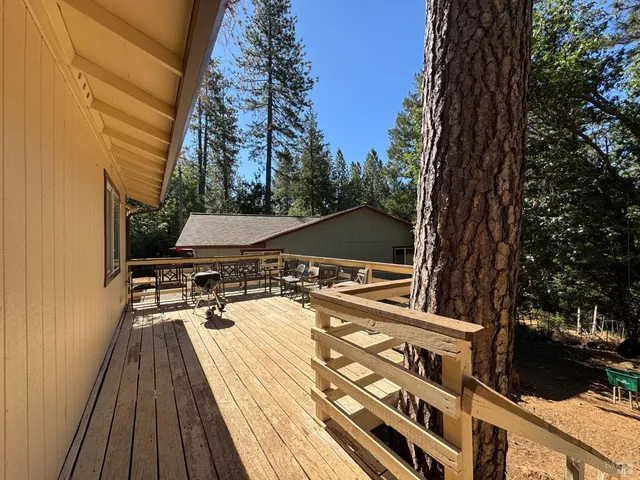 a view of balcony with wooden floor and outdoor seating