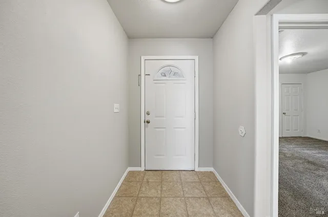 a view of a hallway with closet and wooden floor
