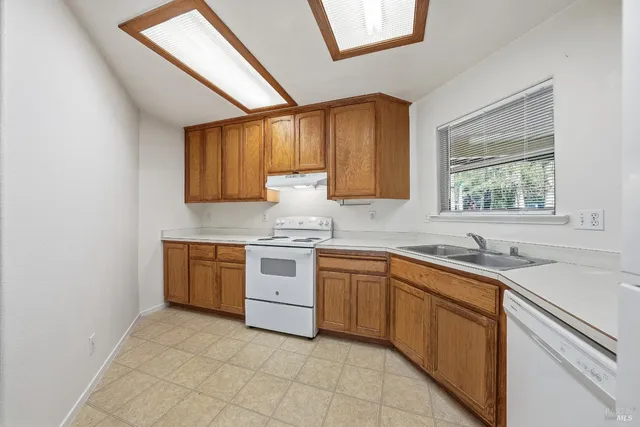 a kitchen with a sink stove and cabinets