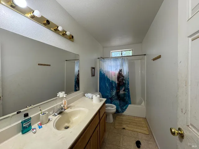 a bathroom with a sink double vanity granite and shower