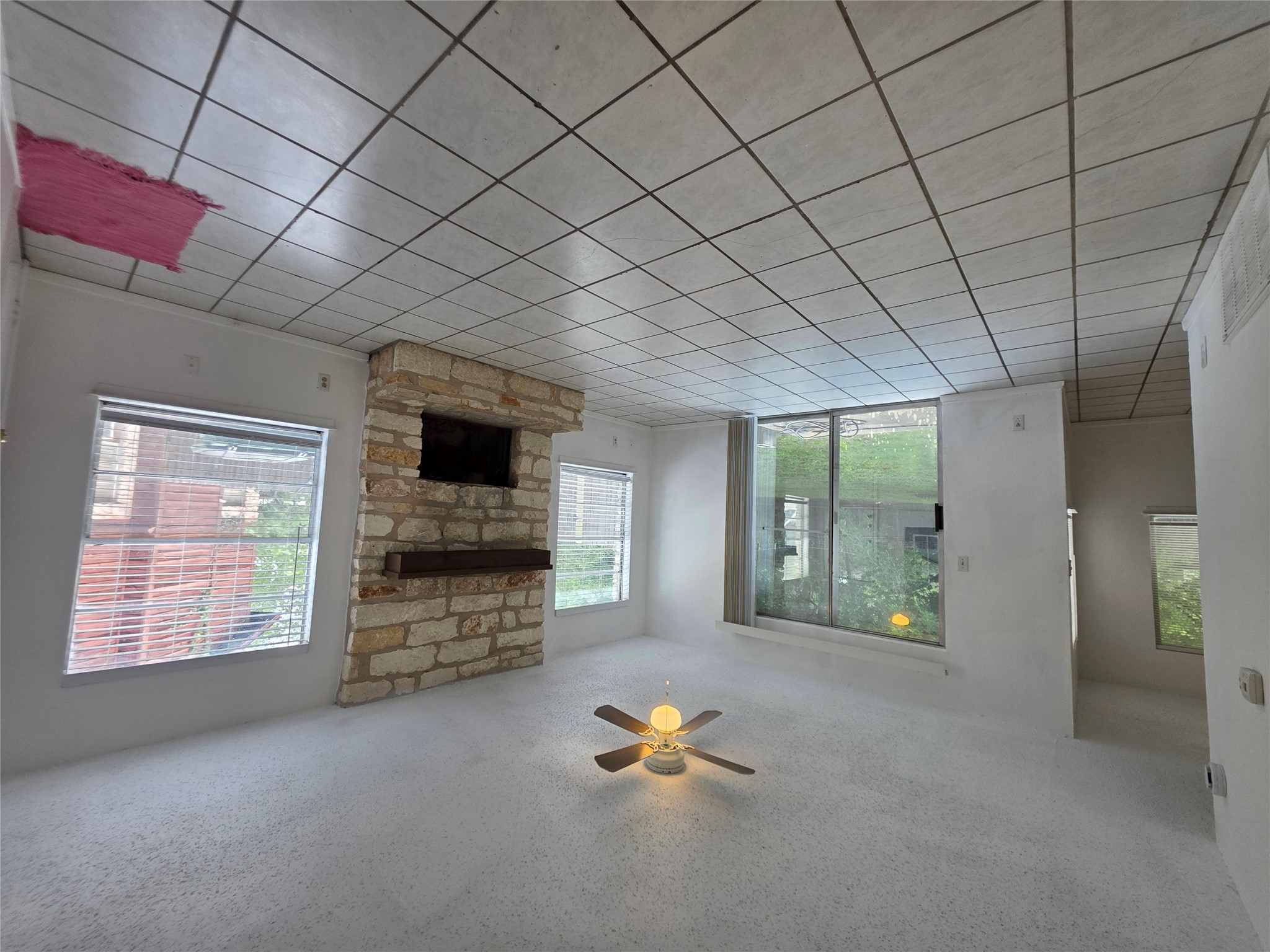 8818 Clearbrook Trail Austin, TX 78729 - Photo 5 of 22 Unit A Living room standing at garage entry looking at patio, on the left side is the kitchen