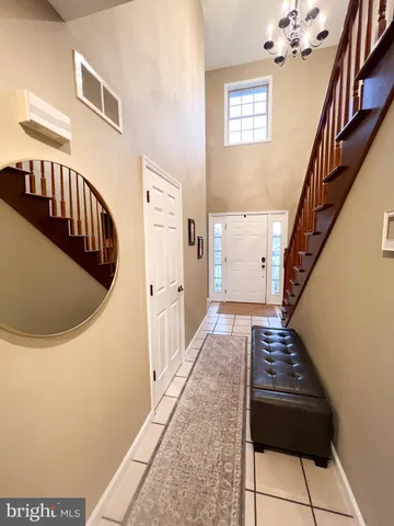 a bedroom with a bed window and a flat screen tv