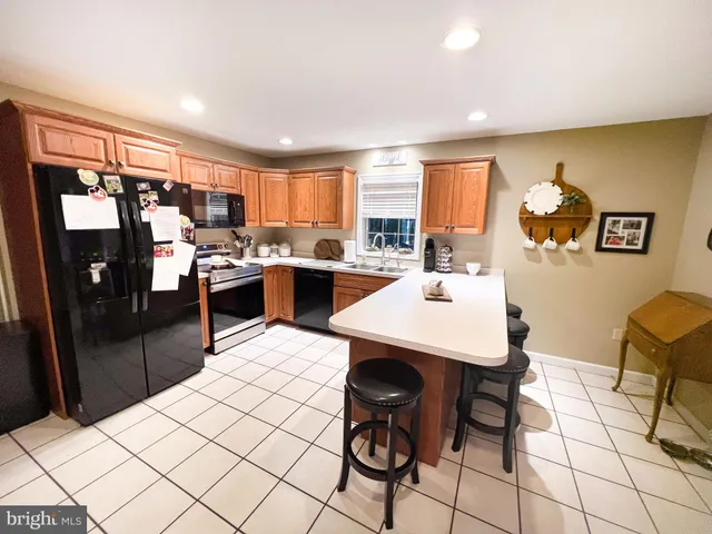 a kitchen with a sink window and cabinets