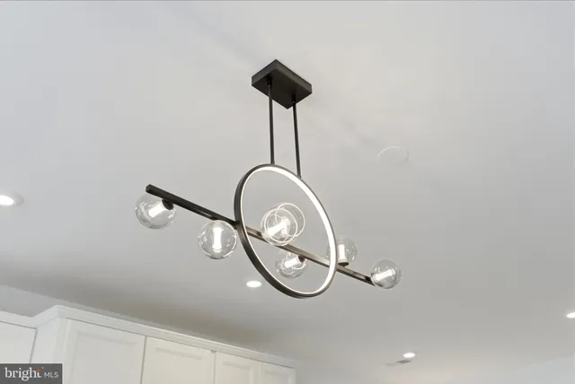 a kitchen with stainless steel appliances a dining table chairs stove and refrigerator