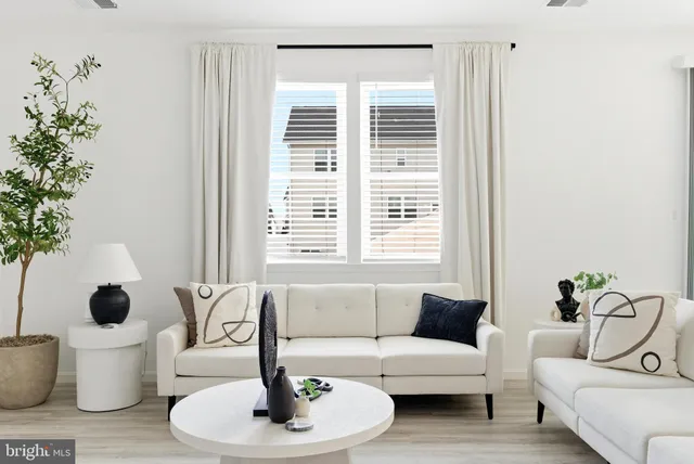 a living room with furniture and kitchen view