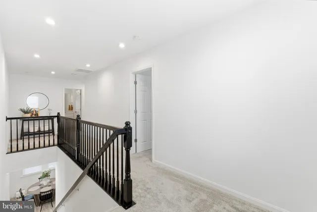 a view of a hallway with wooden floor and windows
