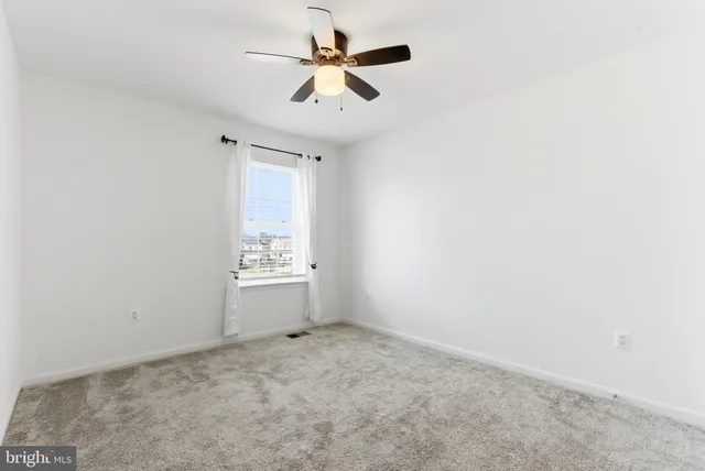 a living room with furniture and a mirror
