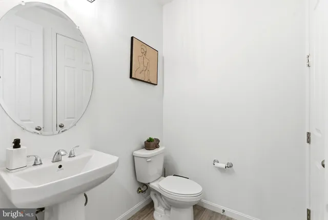 a bathroom with a sink mirror and toilet