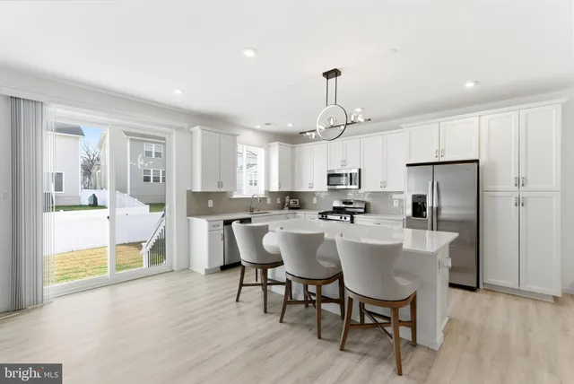 a large kitchen with a table and chairs