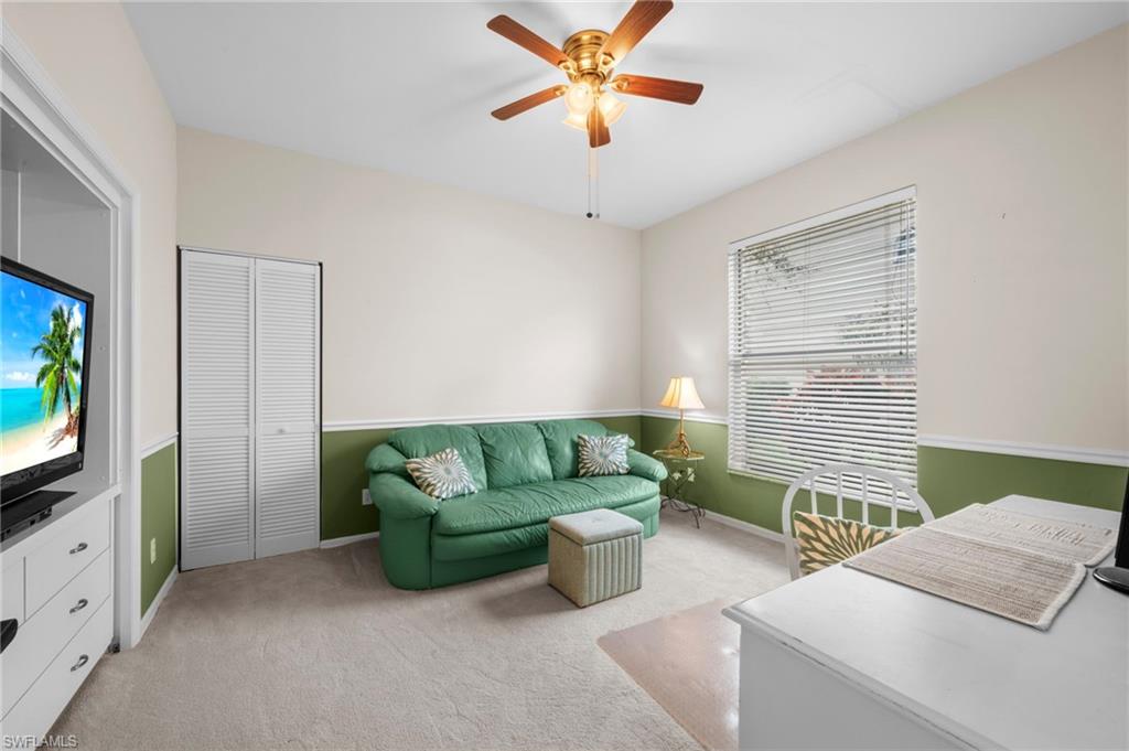 8015 Tiger Cove, Unit 204 Naples, FL 34113 - Photo 20 of 24 a living room with furniture and a flat screen tv