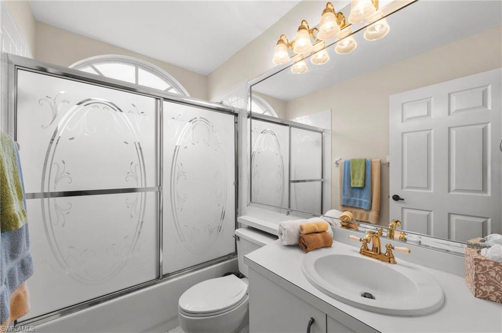 8015 Tiger Cove, Unit 204 Naples, FL 34113 - Photo 21 of 24 a bathroom with a sink toilet and shower