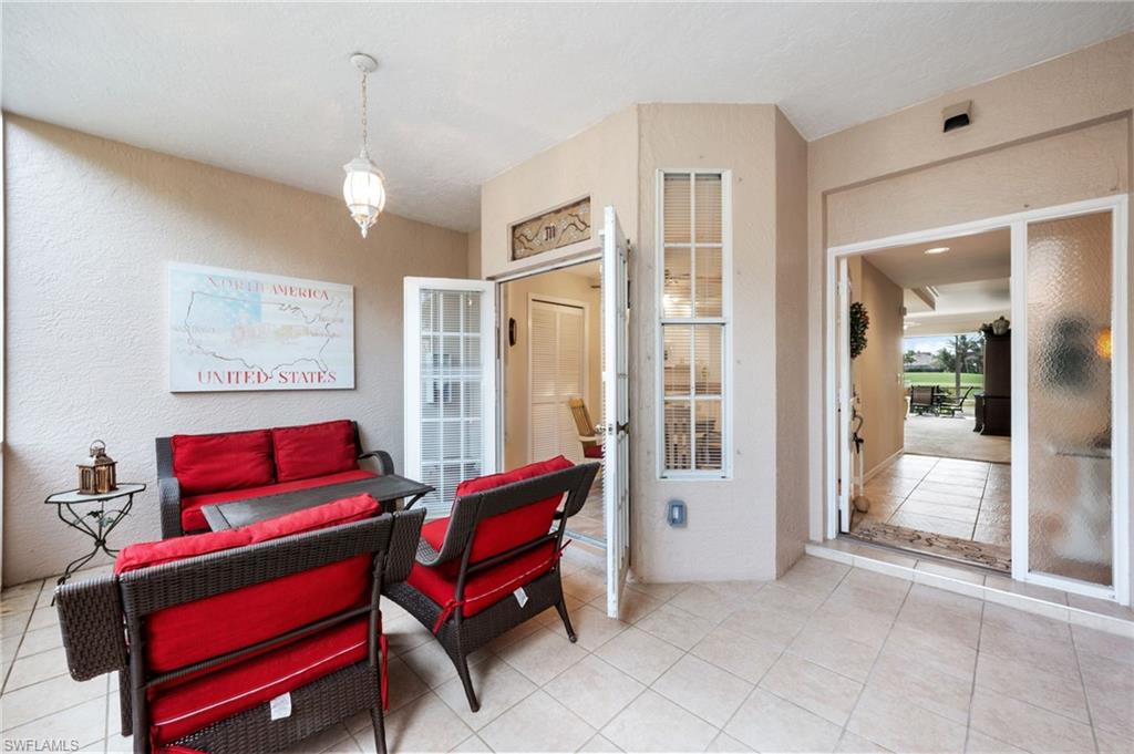8015 Tiger Cove, Unit 204 Naples, FL 34113 - Photo 6 of 24 a living room with furniture and a chandelier