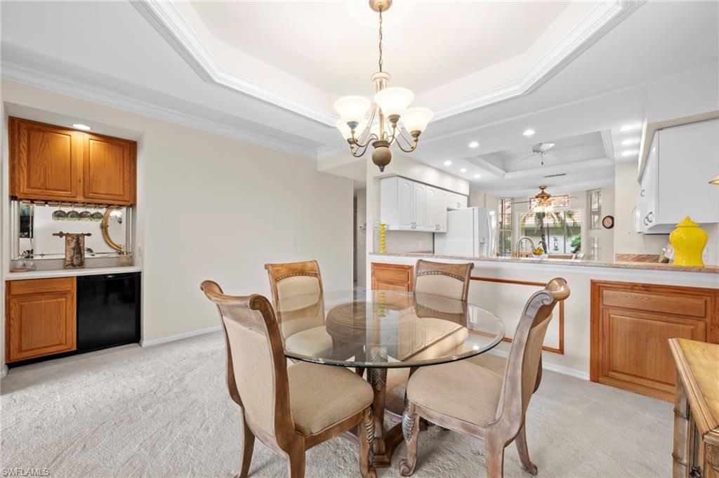 8015 Tiger Cove, Unit 204 Naples, FL 34113 - Photo 9 of 24 a dining room with furniture a window and kitchen view