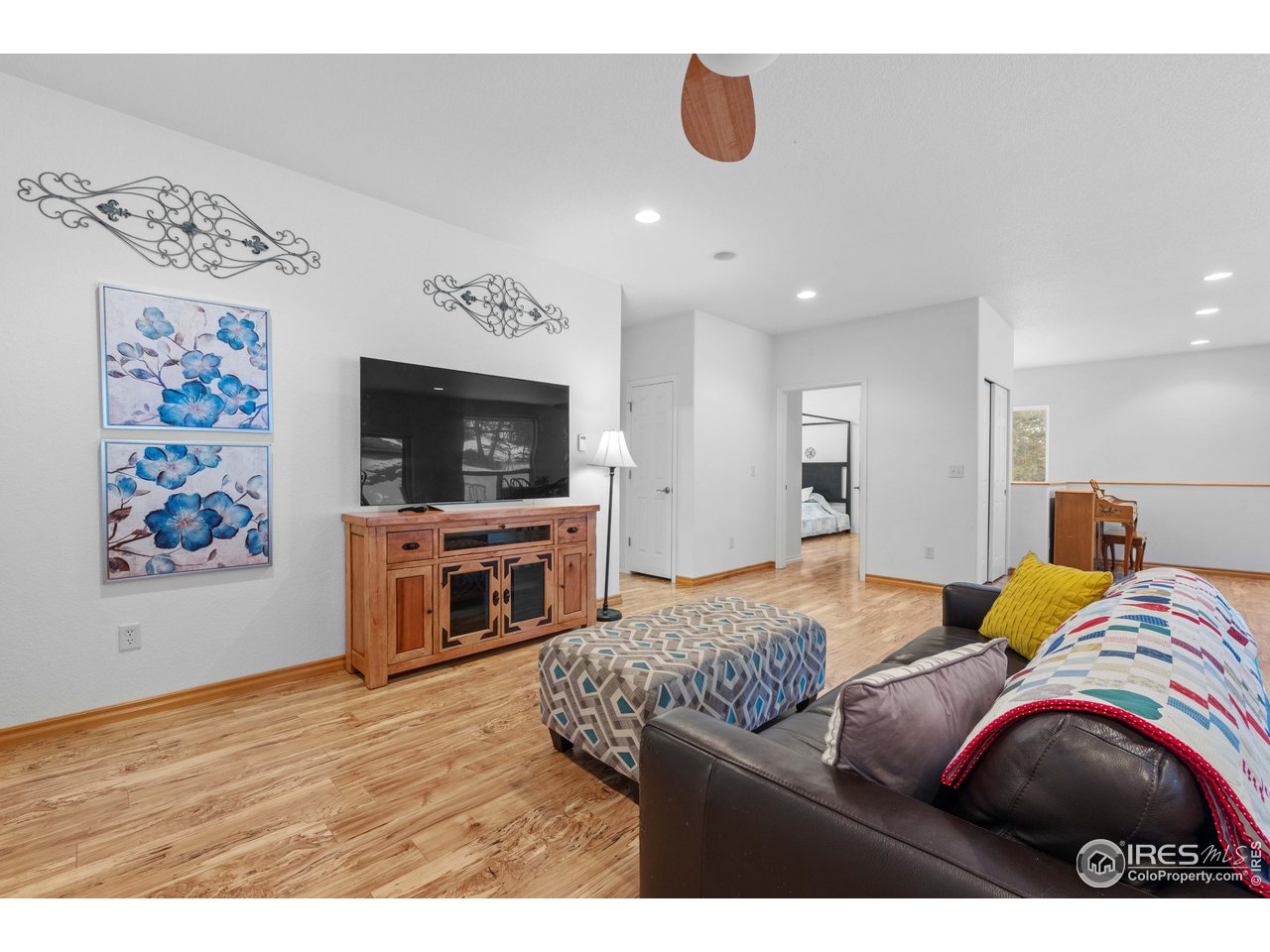 339 Cedar Drive Lyons, CO 80540 - Photo 12 of 37 a bedroom with a bed and a television in it