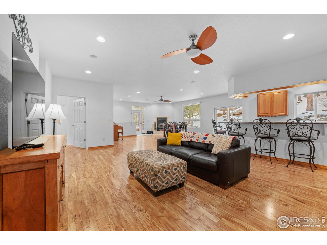 339 Cedar Drive Lyons, CO 80540 - Photo 13 of 37 a living room with furniture kitchen view and a wooden floor