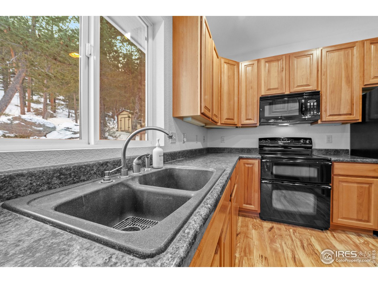 339 Cedar Drive Lyons, CO 80540 - Photo 16 of 37 a kitchen with a sink a stove and cabinets