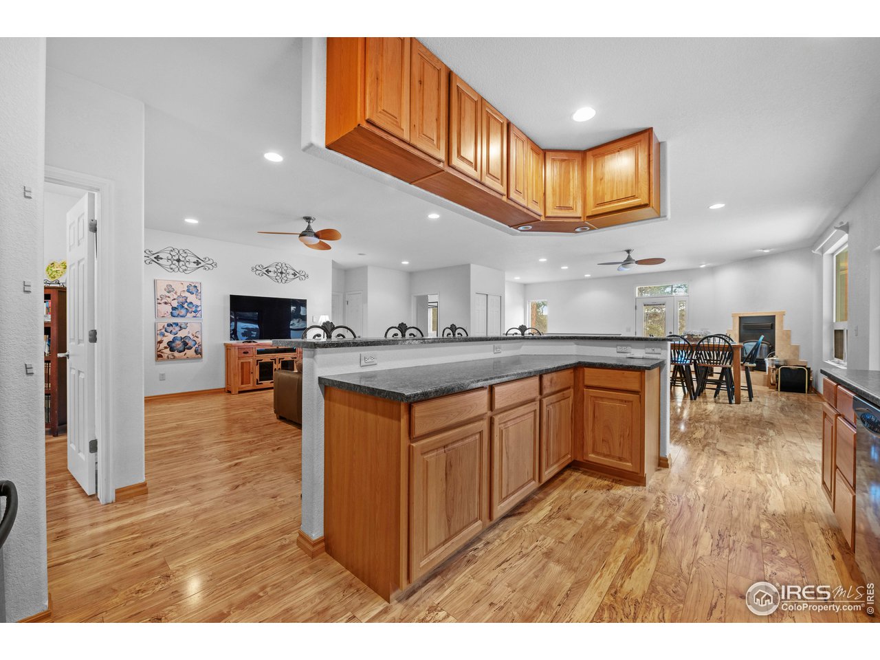 339 Cedar Drive Lyons, CO 80540 - Photo 20 of 37 a kitchen with stainless steel appliances granite countertop a sink a stove top oven a chimney cabinets and wooden floor