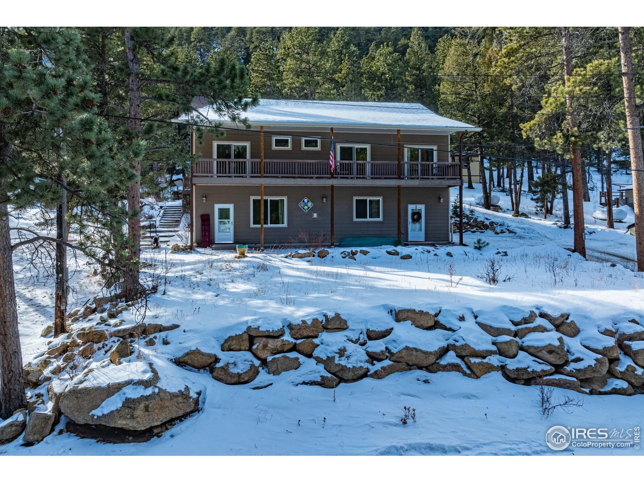 339 Cedar Drive Lyons, CO 80540 - Photo 2 of 37 a front view of a house with swimming pool