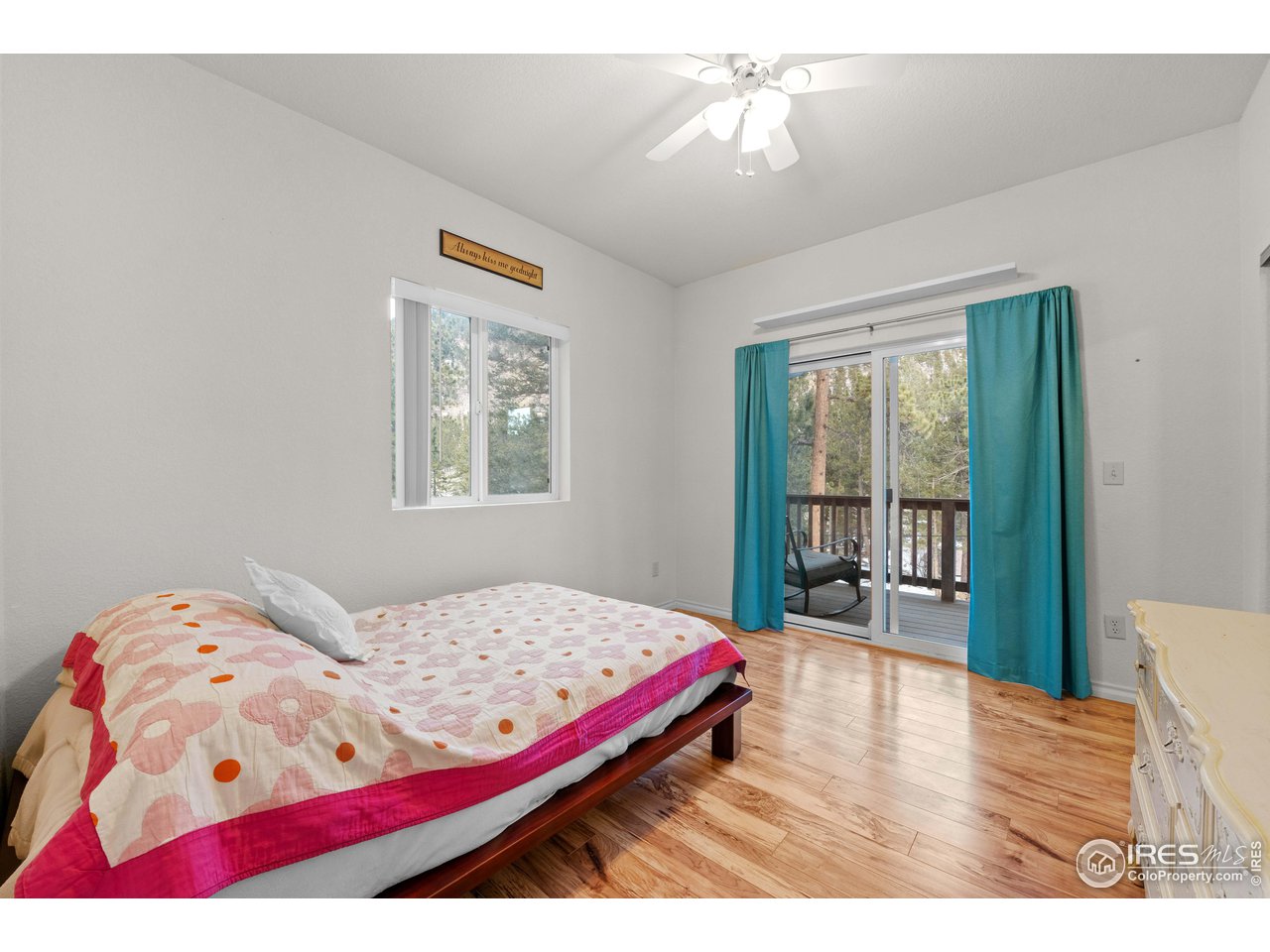 339 Cedar Drive Lyons, CO 80540 - Photo 23 of 37 a bedroom with a bed and a chandelier