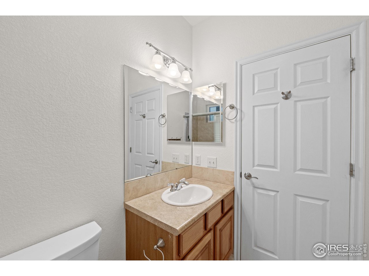 339 Cedar Drive Lyons, CO 80540 - Photo 34 of 37 a bathroom with a sink a mirror and a toilet