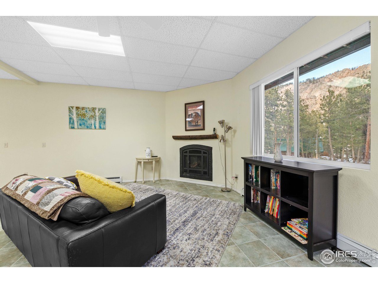 339 Cedar Drive Lyons, CO 80540 - Photo 4 of 37 a living room with furniture a fireplace and a large window
