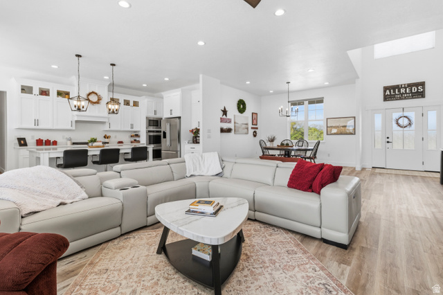 886 North 300th East Spring City, UT 84662 - Photo 13 of 40 Living room with a chandelier and light wood-style floors