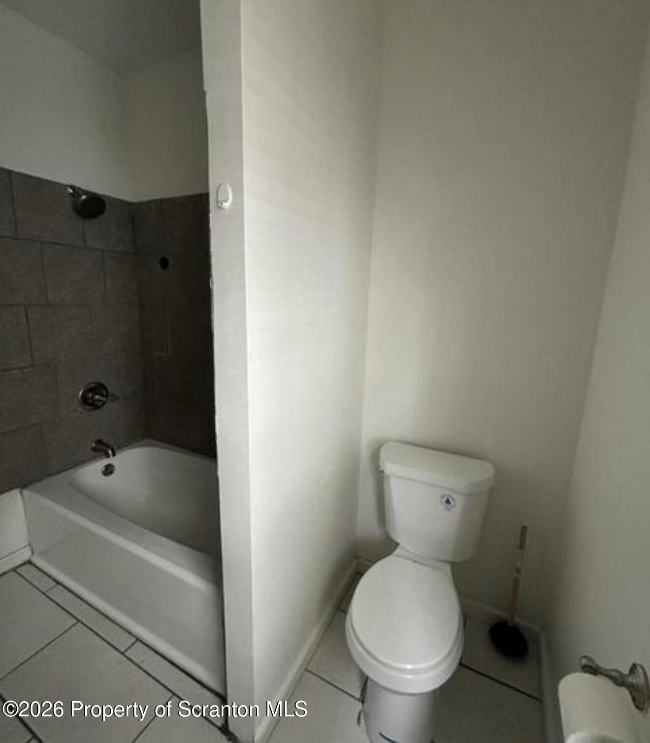 1607 Mulberry Street Scranton, PA 18510 - Photo 12 of 12 a white toilet sitting next to a bath tub