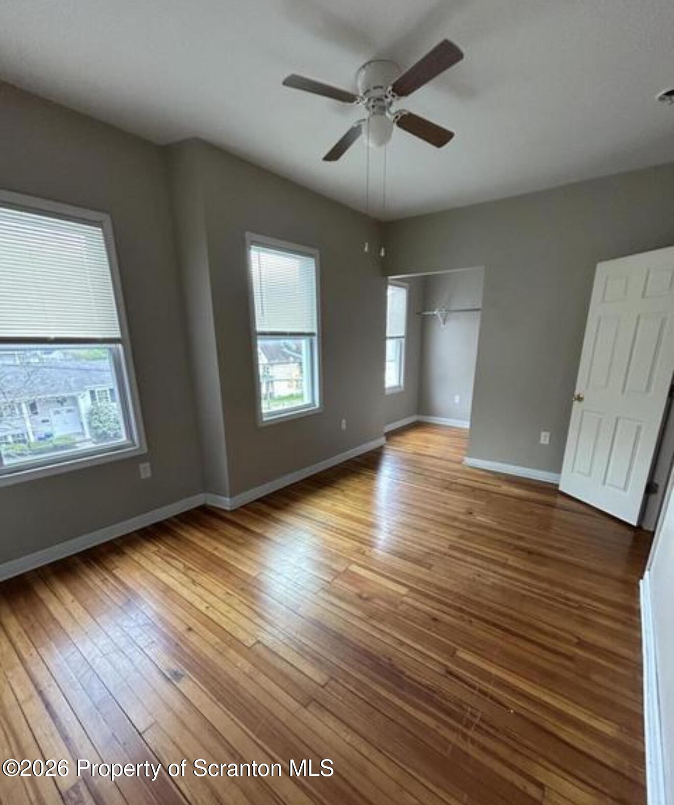 1607 Mulberry Street Scranton, PA 18510 - Photo 3 of 12 a view of an empty room with wooden floor and a window