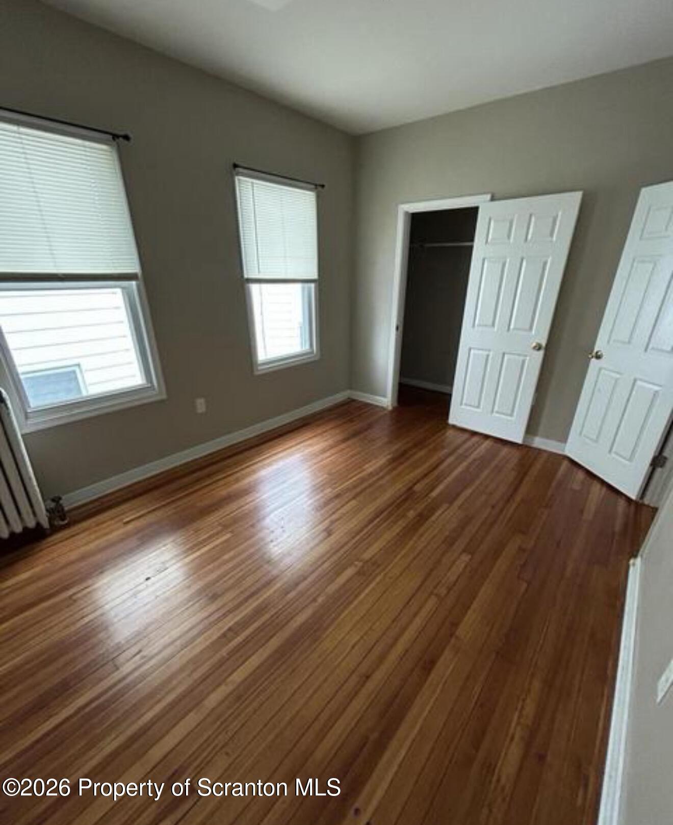 1607 Mulberry Street Scranton, PA 18510 - Photo 6 of 12 a view of an empty room with wooden floor and a window