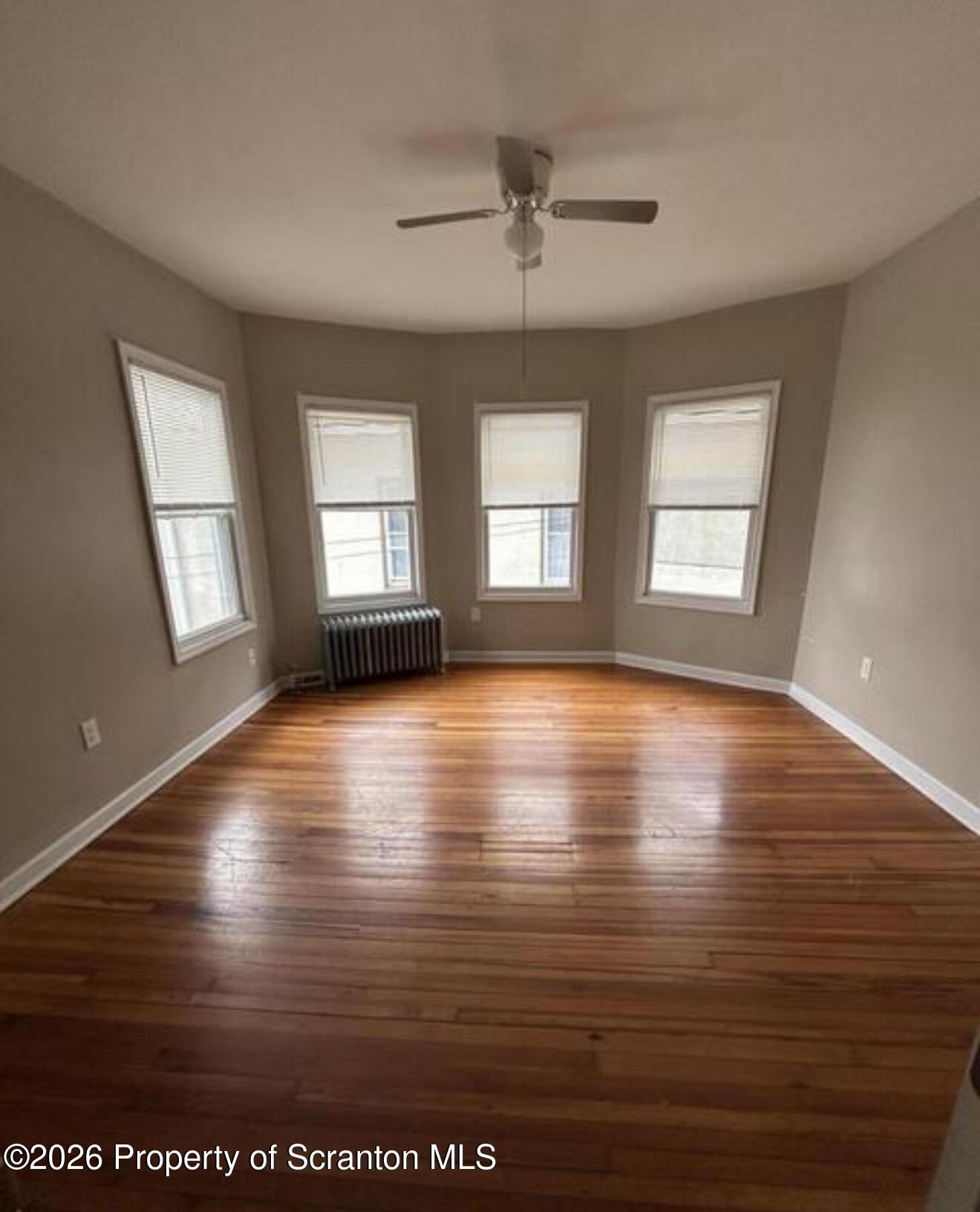 1607 Mulberry Street Scranton, PA 18510 - Photo 7 of 12 a view of empty room with window and wooden floor