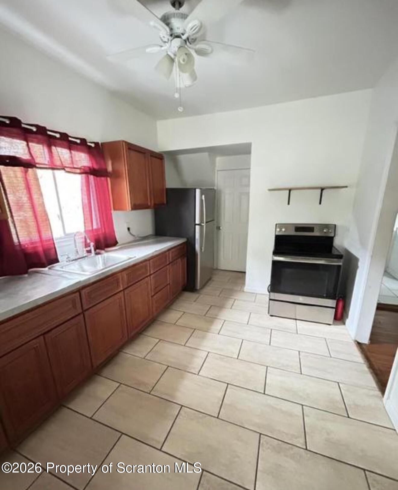 1607 Mulberry Street Scranton, PA 18510 - Photo 8 of 12 a kitchen with a sink a stove and cabinets
