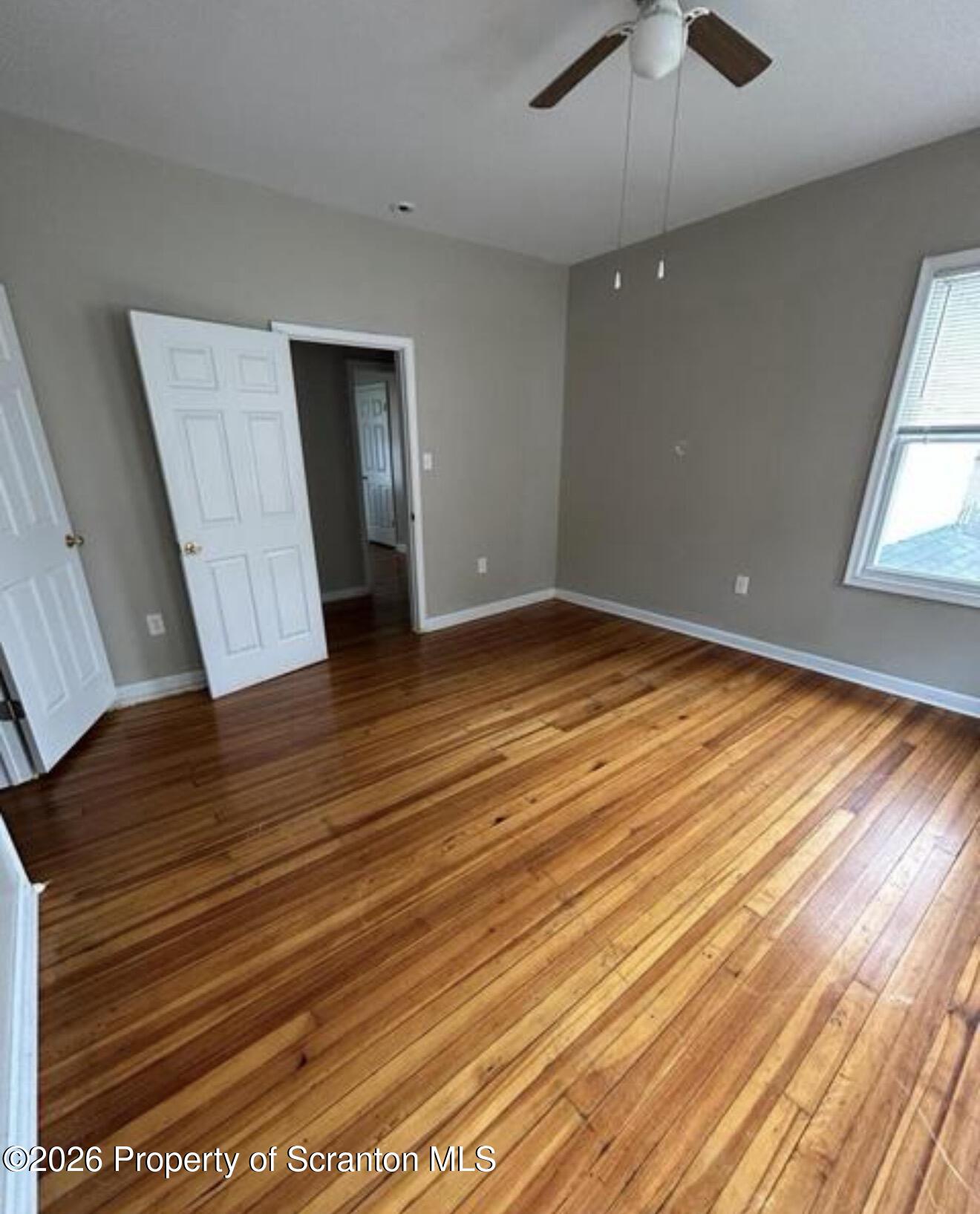 1607 Mulberry Street Scranton, PA 18510 - Photo 10 of 12 wooden floor in an empty room with a window