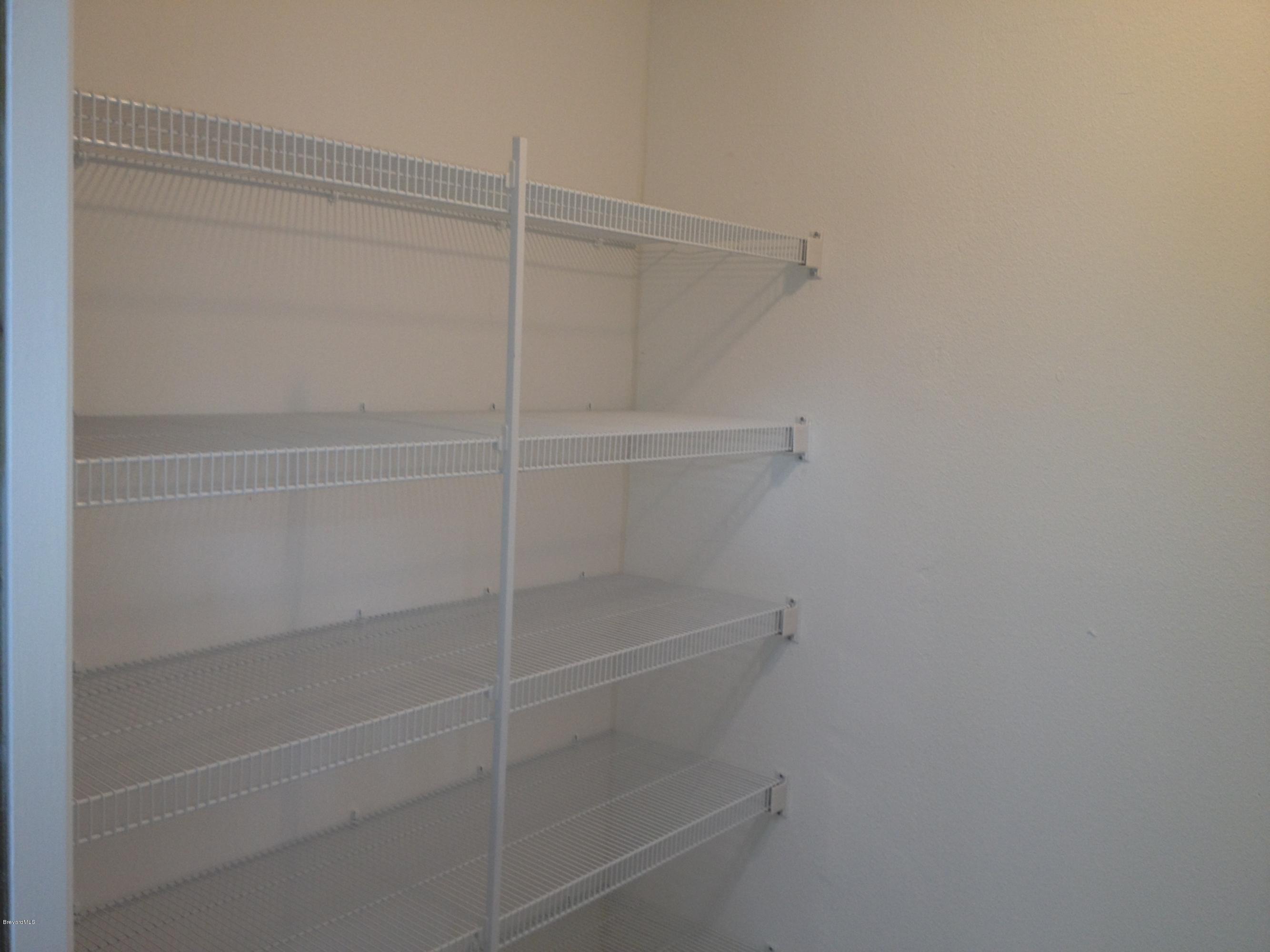 385 Rheine Road Northwest Palm Bay, FL 32907 - Photo 7 of 15 a view of a room with shelf on the wall