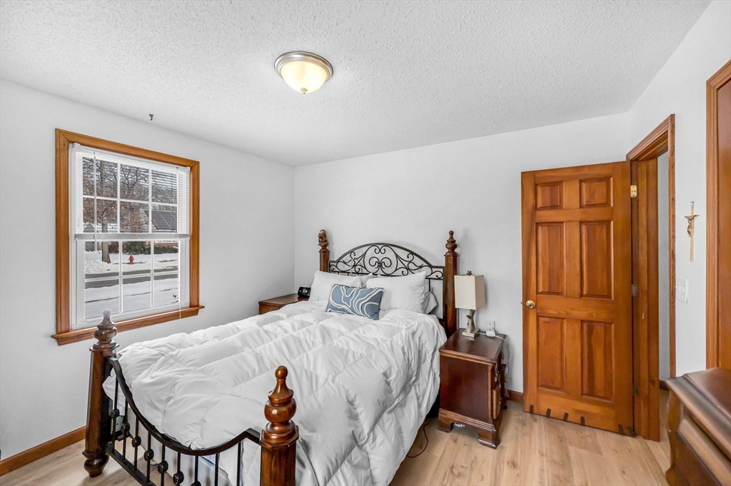 365 Maple Road Longmeadow, MA 01106 - Photo 14 of 32 a bedroom with a bed and wooden floor