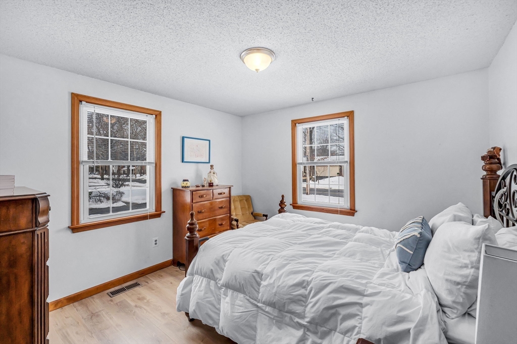 365 Maple Road Longmeadow, MA 01106 - Photo 15 of 32 a bedroom with a bed and a dresser next to a window