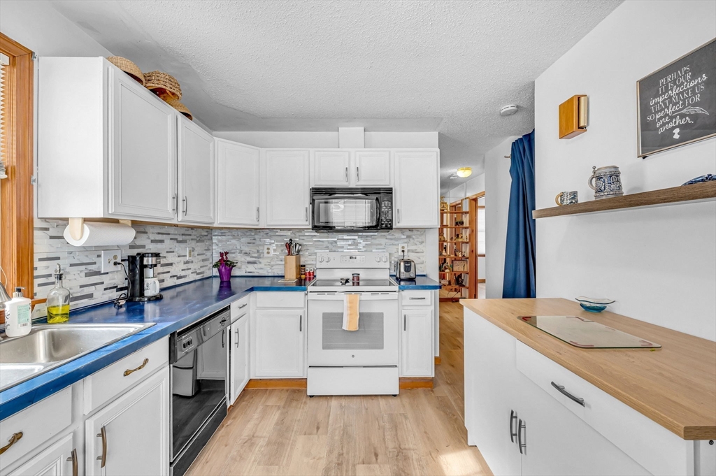365 Maple Road Longmeadow, MA 01106 - Photo 7 of 32 a kitchen with a sink cabinets and wooden floor