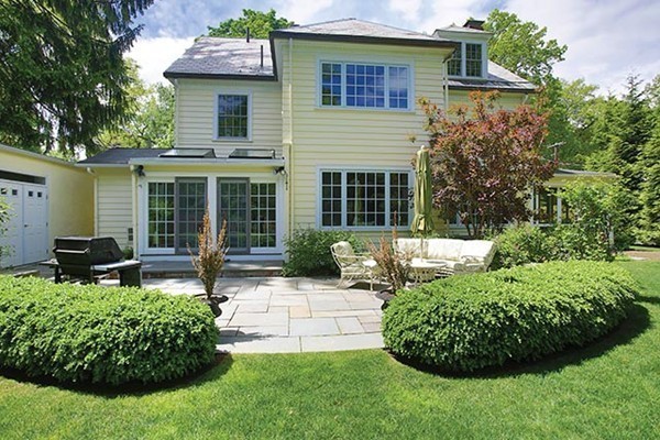 15 Bonad Road Newton, MA 02465 - Photo 15 of 16 a front view of a house with a garden