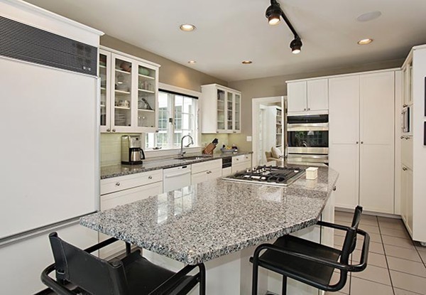 15 Bonad Road Newton, MA 02465 - Photo 6 of 16 a kitchen with kitchen island granite countertop a stove cabinets and sink